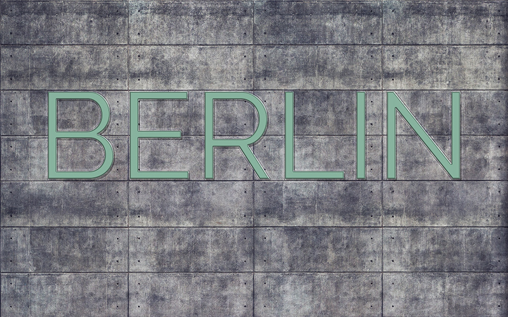 Papier peint photo - mur en béton avec une grande inscription BERLIN au design industriel