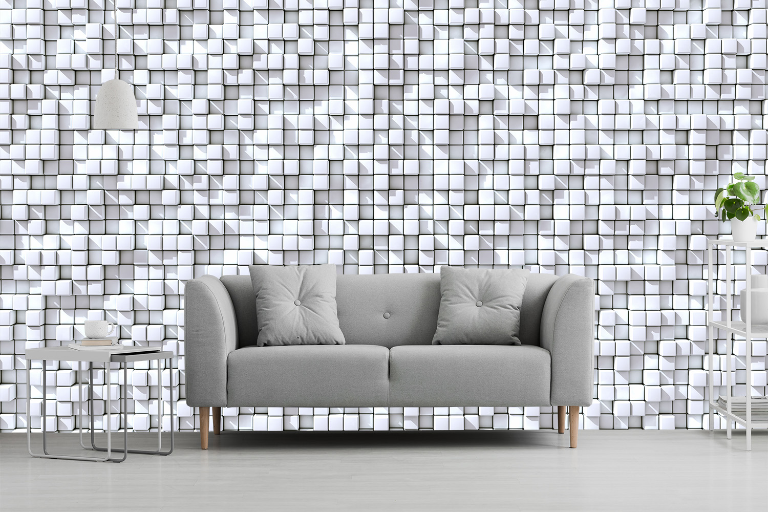 Papier peint photo - Canapé gris devant un mur avec un motif de cubes 3D en blanc et gris, décoré avec une table et une plante