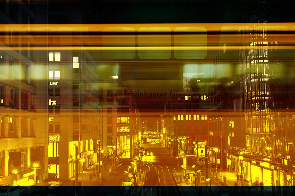 Papier peint photo - paysage nocturne d'une ville avec des bâtiments illuminés et un train en mouvement au premier plan