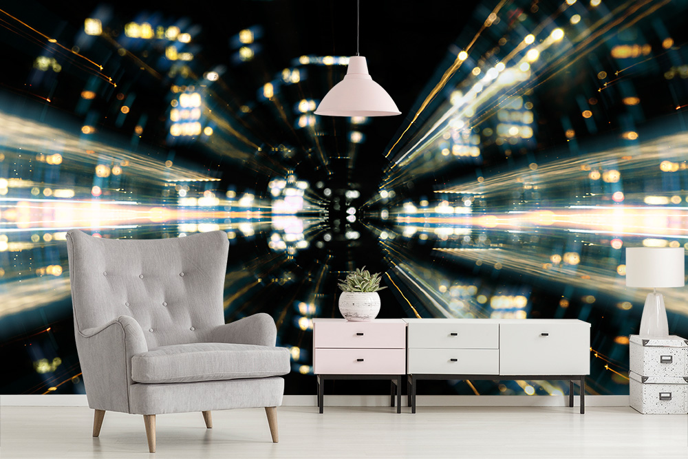Papier peint photo - Lumières futuristes au design urbain derrière un salon confortable avec un fauteuil gris et un buffet